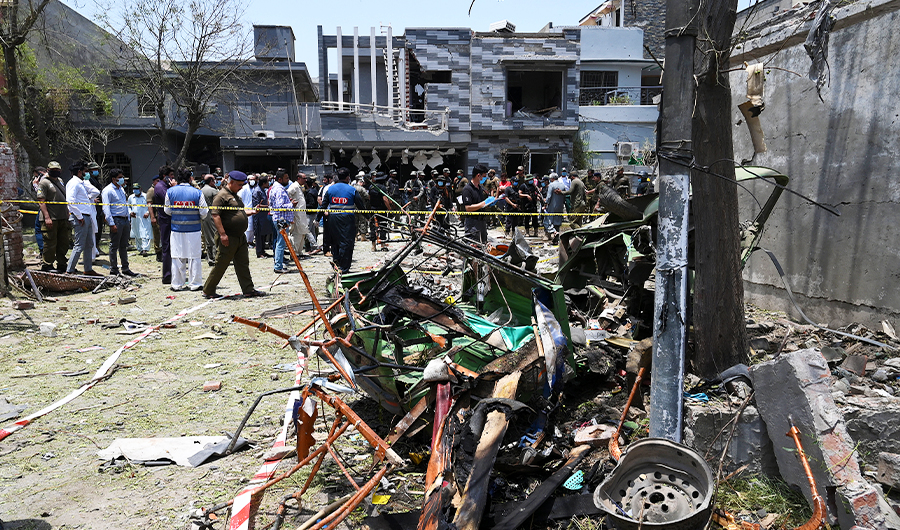 Security officials inspect the site of an explosion that killed at least two people and wounded another 15 in Pakistan's eastern city of Lahore on June 23, 2021. (AFP)