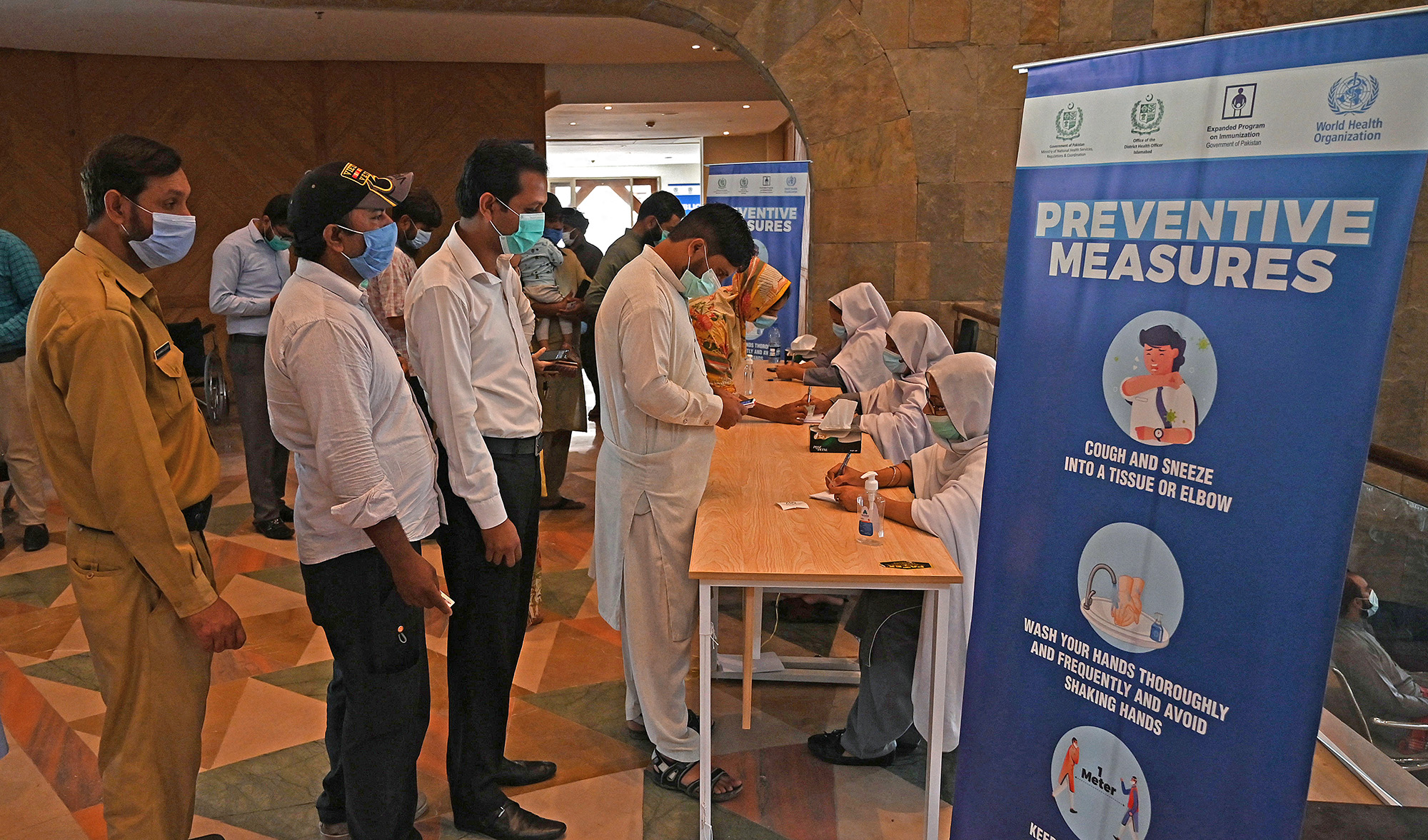 People register to get a dose of the Covid-19 vaccine at a mass vaccination center in Islamabad, Pakistan, on June 3, 2021. (AFP/File)