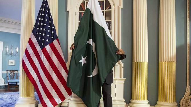 A State Department contractor adjust a Pakistan national flag before a meeting between senior US and Pakistani officials on the sidelines of a White House Summit on Countering Violent Extremism at the State Department in Washington February 19, 2015. (REUTERS)