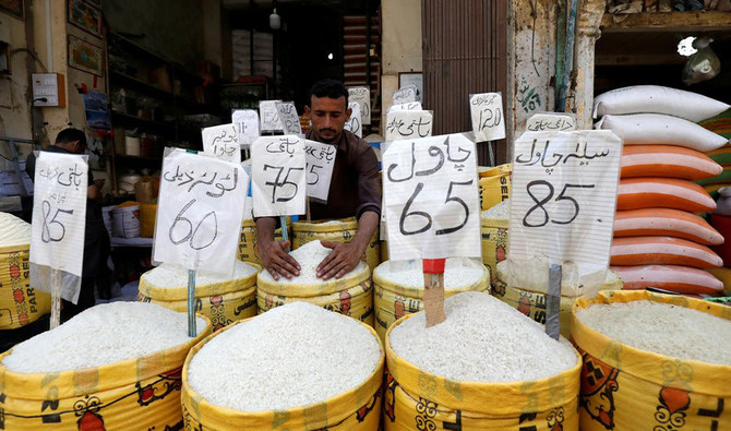A vendor arranges different types of rice, with their prices displayed, at his shop in a wholesale market in Karachi, Pakistan April 2, 2019. (REUTERS)