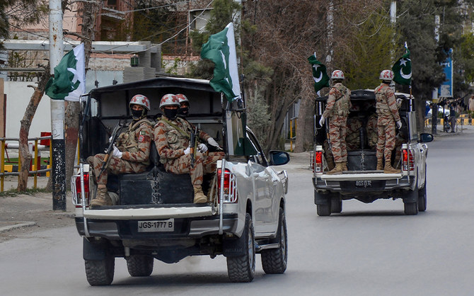 Security personnel patrol with vehicles on a street in Quetta, Pakistan, on March 25, 2020. (AFP/File)