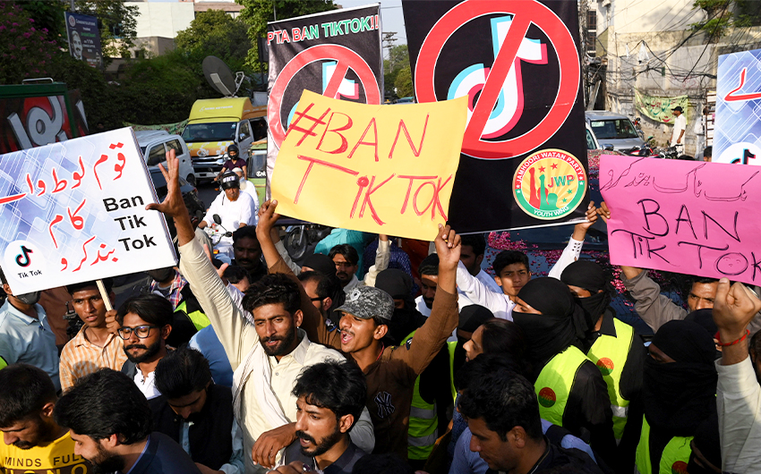 Activists carry placards during a protest to demand the ban of TikTok social media, in Lahore, Pakistan, on June 18, 2021. (AFP/File)