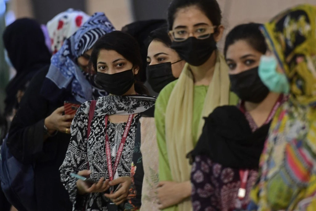 Pakistani women wait for their turn to receive a dose of the Sinovac COVID-19 vaccine at a vaccination camp in Karachi on June 3, 2021. (AFP)