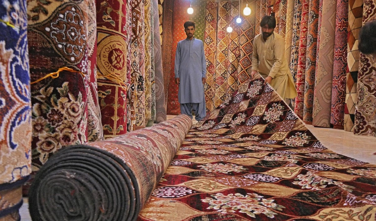 Abdul Samad displays carpets at his shop on Double Road in Quetta, Balochistan, June 2, 2021. (AN photo by Saadullah Akhter)