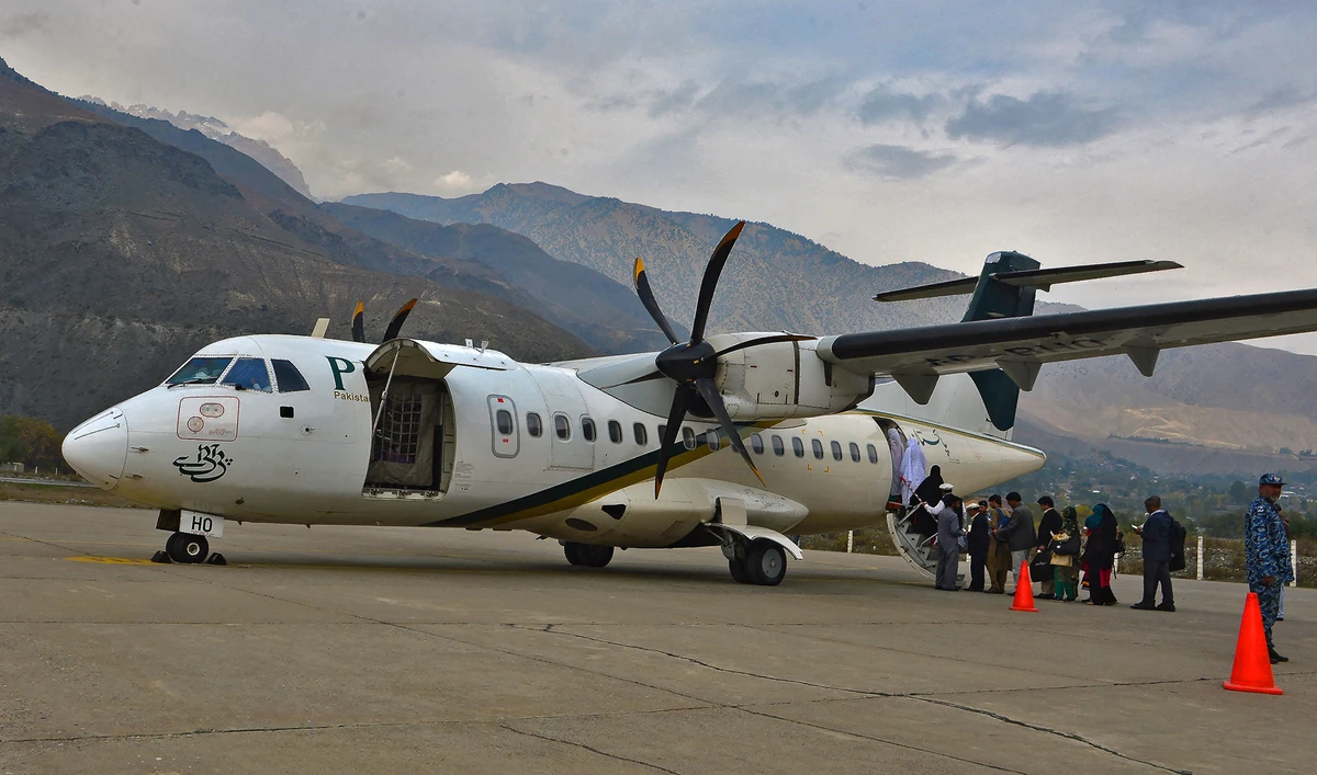 In this file picture taken on November 1, 2015, passengers of Pakistan International Airlines (PIA) wait to board an ATR plane for Islamabad, in Chitral, Pakistan. (AFP/File)