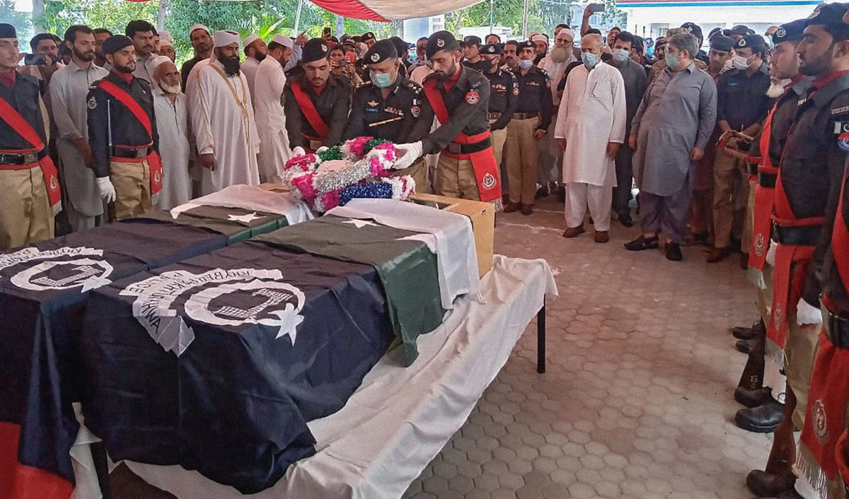 Pakistani police officials pay honor to two officers killed by gunmen while guarding a polio team in Mardan, Khyber Pakhtunkhwa, on June 9, 2021. (Photo courtesy: KP Director General Information and Public Relations)