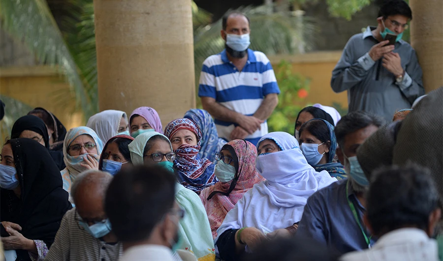 People wait to register themselves to get inoculated with the dose of the Covid-19 coronavirus Sinopharm vaccine at a vaccination camp in Karachi on May 24, 2021. (AFP)