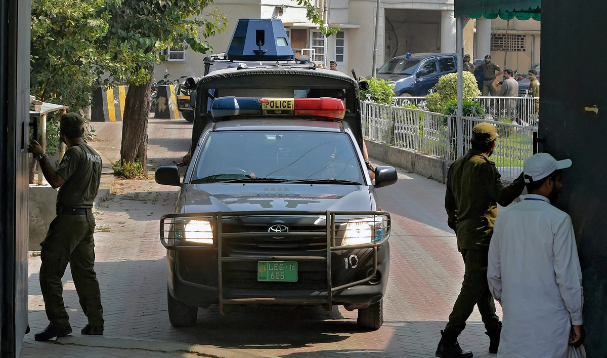 A police car escorts an armed vehicle carrying a suspect of a gang rape as they leave the court premises in Lahore, Pakistan, on October 13, 2020. (AFP/File)