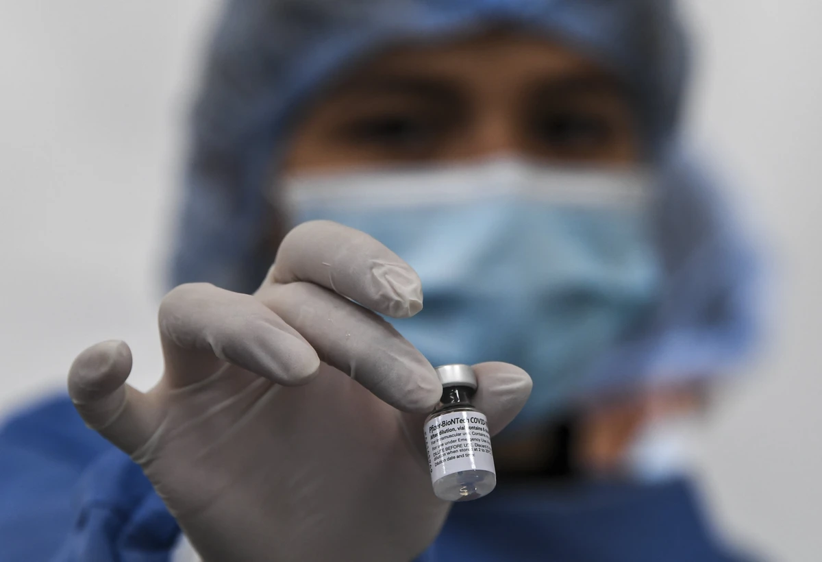 A nurse holds a vial of the Pfizer-BioNTech COVID-19 coronavirus vaccine at a shopping center in which people over 50 are vaccinated amid the ongoing novel coronavirus pandemic, in Bogota, on June 4, 2021. (AFP)