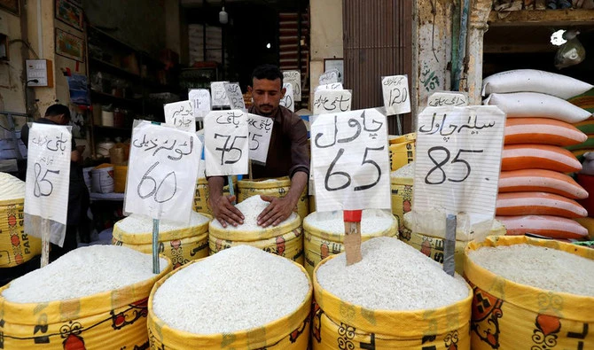 A vendor arranges different types of rice, with their prices displayed, at his shop in a wholesale market in Karachi, Pakistan April 2, 2019. (REUTERS)
