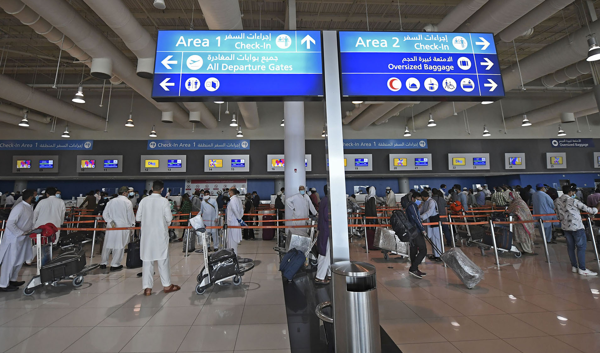 Pakistani nationals check in at the Dubai International Airport before leaving the Gulf Emirate on a flight back to their country, on May 7, 2020, amid the COVID-19 coronavirus pandemic. (AFP/File)
