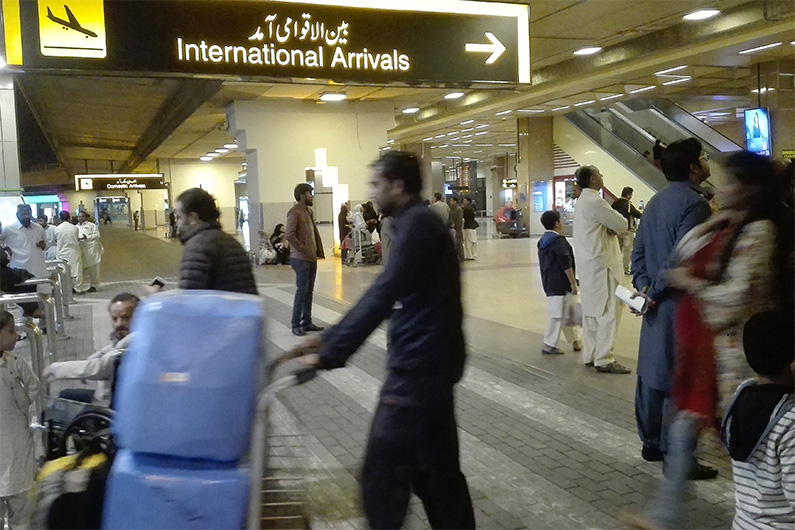 Passengers walk after their arrival at the Jinnah International Airport in Karachi on January 31, 2020. (AFP)