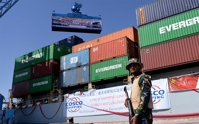 A Pakistani Naval personnel stands guard beside a ship carrying containers during the opening of a trade project in Gwadar port, Pakistan, on November 13, 2016. (AFP/File)