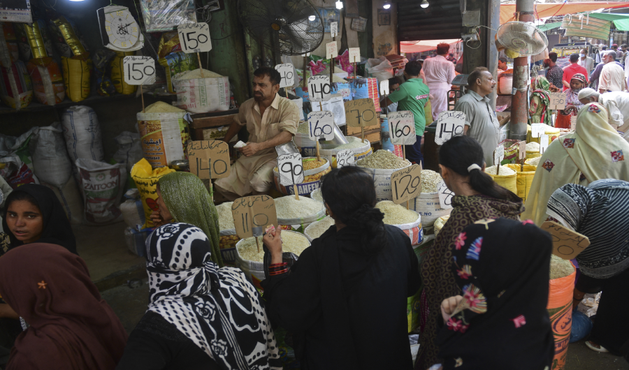Customers crowd at a market in Karachi on June 10, 2021. (AFP)