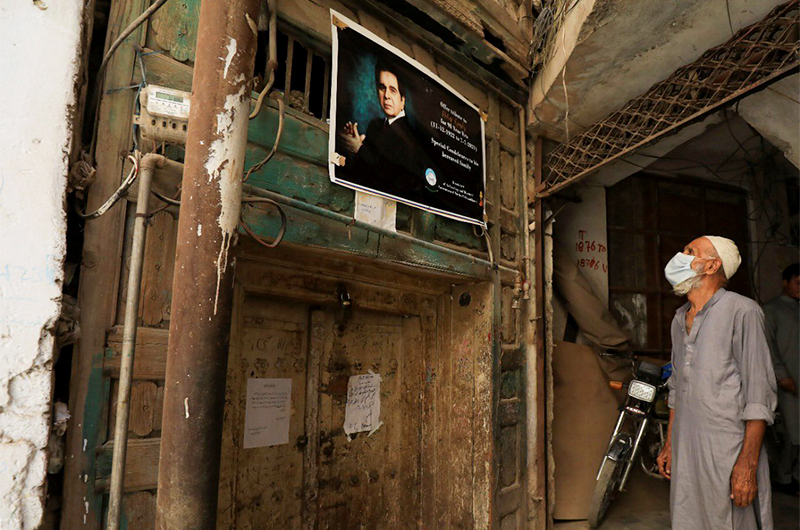 A man reads a sign, placed by the Archaeology and Museums Department, on a closed entrance of the childhood home of Bollywood actor Dilip Kumar after his death in Mumbai, in Peshawar, Pakistan July 7, 2021. (REUTERS)