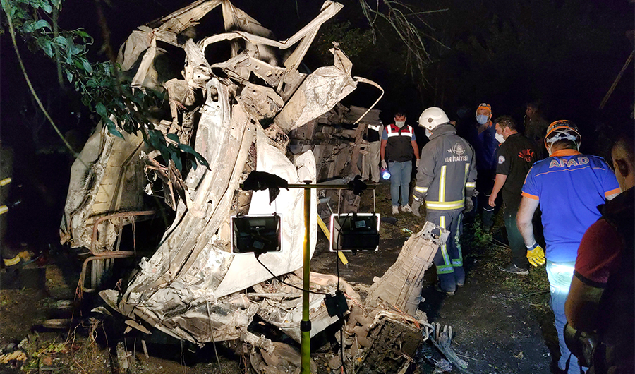 Emergency workers emergency workers work through the burnt-out wreckage as others treat wounded survivors by the roadside in Muradiye in Turkey's Van province, which borders Iran, on July 11, 2021. (AP)