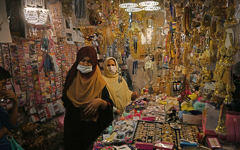 Women buy jewelry at market area during shopping ahead of the upcoming festival of Eid in Rawalpindi, Pakistan, on May 6, 2021. (AFP/File)