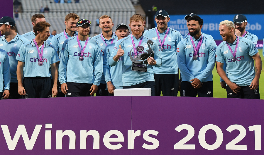 England captain Ben Stokes holding the trophy with teammates after the third one day international (ODI) cricket match between England and Pakistan at Edgbaston cricket ground in Birmingham on July 13, 2021. (AFP)