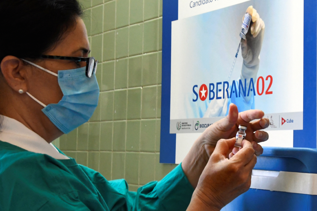 In this file photo taken on March 31, 2021, nurse Xiomara Rodriguez prepares a Cuban Soberana 2 vaccine candidate to be administered to a volunteer during its trial Phase III in Havana. (AFP)