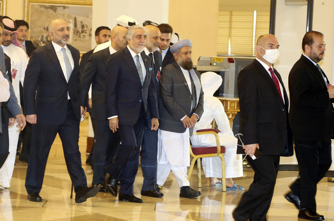 Abdullah Abdullah, center, chairman of Afghanistan's High Council for National Reconciliation, arrives with his delegation for the opening session of the peace talks between the Afghan government and the Taliban in Doha, Qatar on September 12, 2020. (AP)