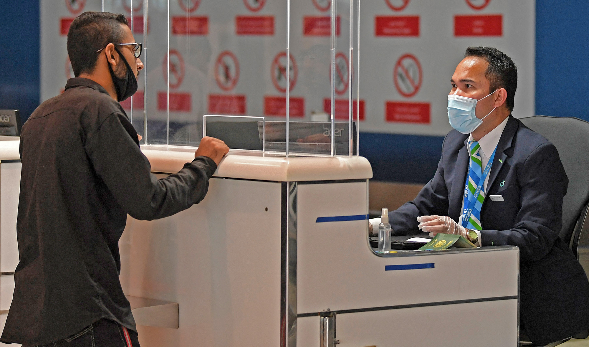 A Pakistani national checks in at the Dubai International Airport before leaving the Gulf Emirate on a flight back to his country, on May 7, 2020. (AFP/File)