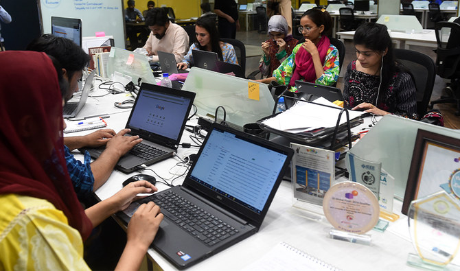 People work at their stations at a start-up incubator, in Lahore, Pakistan on on May 24, 2019. (AFP/File)