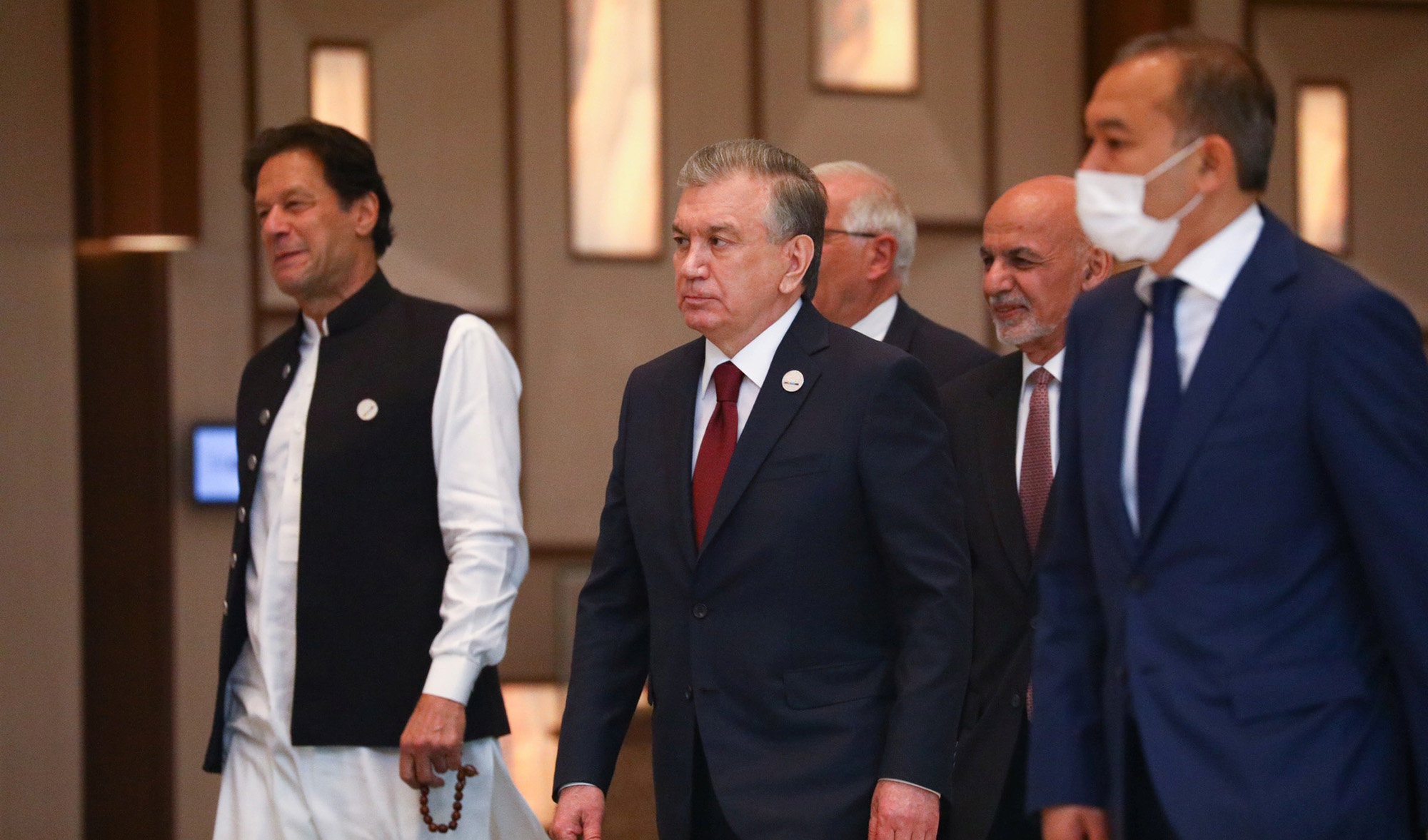 Uzbekistan's President Shavkat Mirziyoyev, Afghanistan's President Ashraf Ghani and Pakistan's Prime Minister Imran Khan walk to attend Central-South Asia trade Summit in Tashkent, Uzbekistan July 16, 2021. (Russian Foreign Ministry via REUTERS)