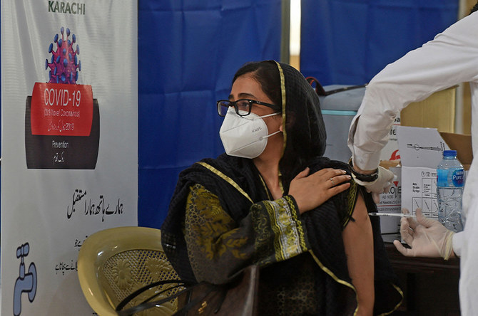 A woman is inoculated with a Covid-19 coronavirus vaccine at a vaccination center in Karachi, Pakistan, on March 16, 2021. (AFP)