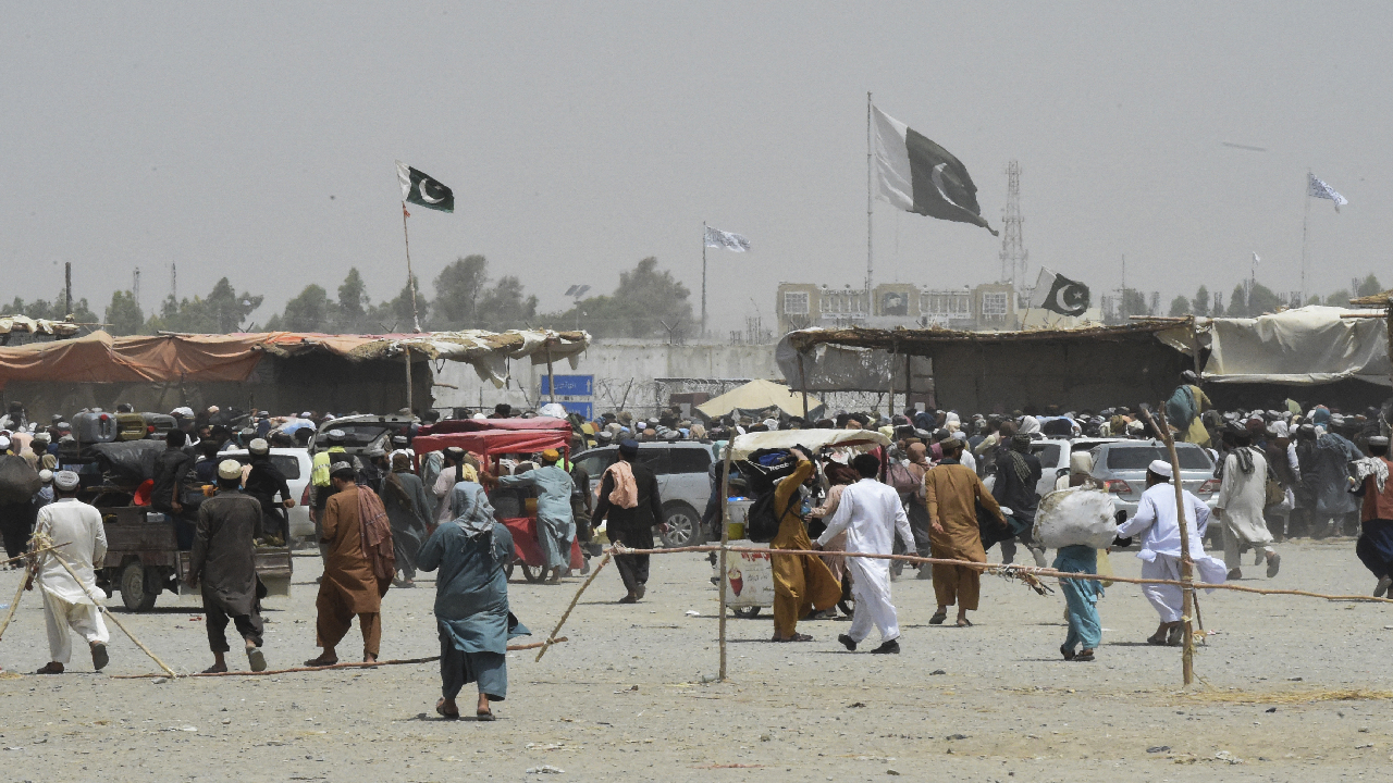 People gather at a border crossing point in Pakistan's border town of Chaman on July 17, 2021. (AFP)