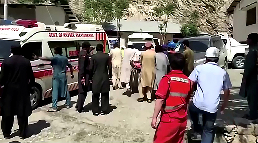People wheel a gurney towards an ambulance outside a hospital in Dasu, after a bus with Chinese nationals on board plunged into a ravine in Upper Kohistan following a blast, Pakistan July 14, 2021 in this still image taken from video. (REUTERS)