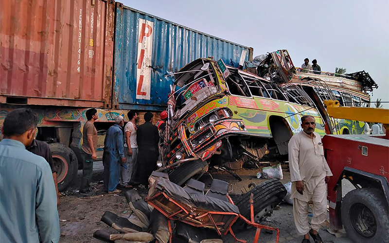 Residents and rescue workers at the site of a deadly bus accident near Dera Ghazi Khan, Pakistan, on July 19, 2021. (Photo courtesy: Punjab Province's Emergency Service Rescue 1122 via AP)
