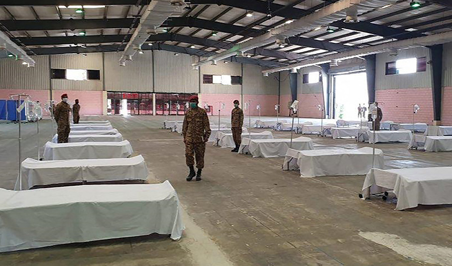 In this handout photograph taken and released by the Sindh Health Ministry on March 20, 2020, soldiers wearing facemasks are seen at the mass isolation center prepared in the Expo Center in Karachi. (AFP)