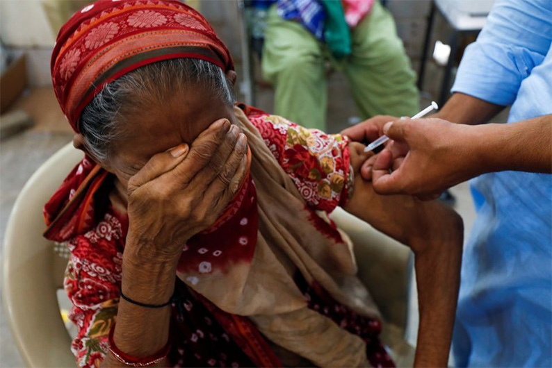 Basanti, 71, reacts as she receives a dose of the coronavirus disease (COVID-19) vaccine at a vaccination center in Karachi, Pakistan June 9, 2021. (REUTERS)