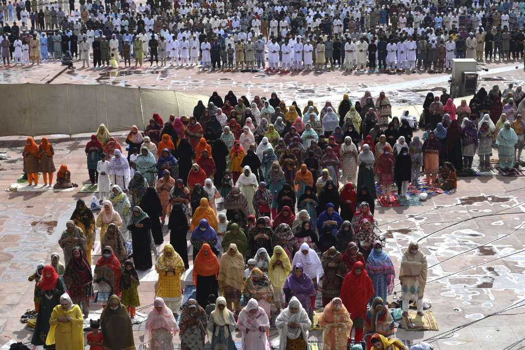 Muslims offer prayers at the Badshahi Mosque in Lahore on the first day of Eid Al-Adha on July 21, 2021. (AFP)