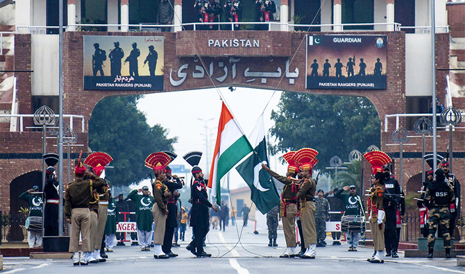 Indian Border Security Force personnel (dressed in brown) and Pakistani Rangers (dressed in black) take part in the Beating Retreat ceremony at the India-Pakistan border in Wagah, on January 6, 2020. (AFP/File)