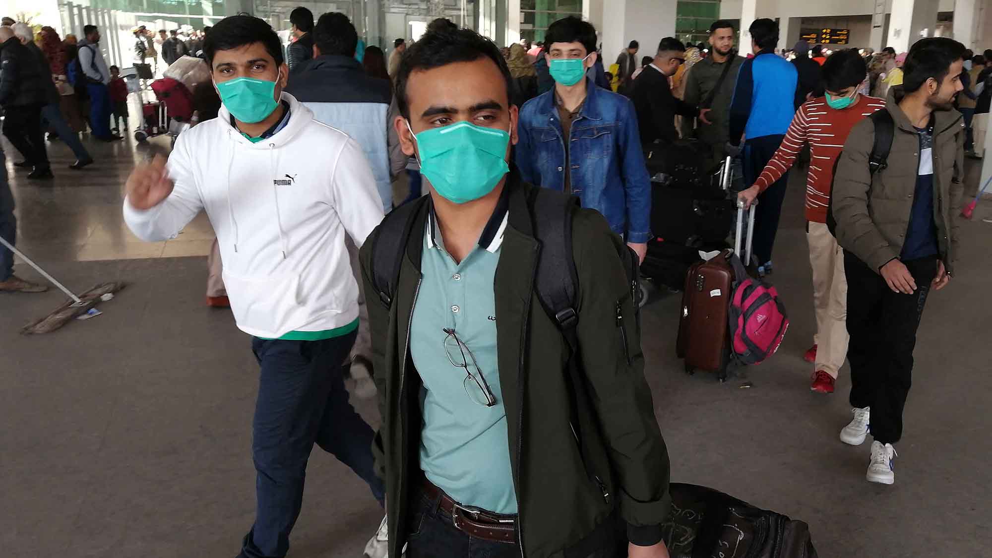 Pakistani passengers wearing face masks arrive at the Islamabad International Airport on February 3, 2020. (AFP/File)