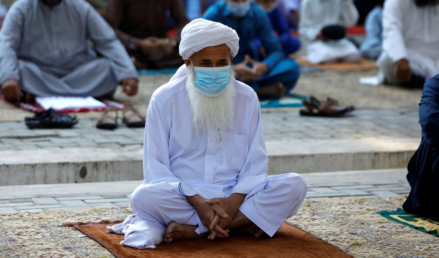 A man wears protective mask sitting in a mosque in Peshawar, Pakistan May 13, 2021. (REUTERS)