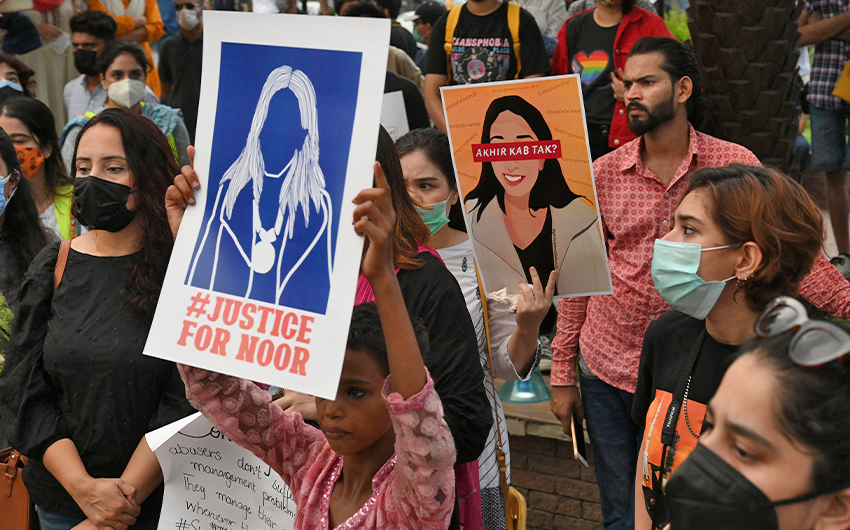 Women rights activists hold placards during a demonstration in Lahore, Pakistan, on July 24, 2021, against the brutal killing of Noor Mukadam. (AFP)