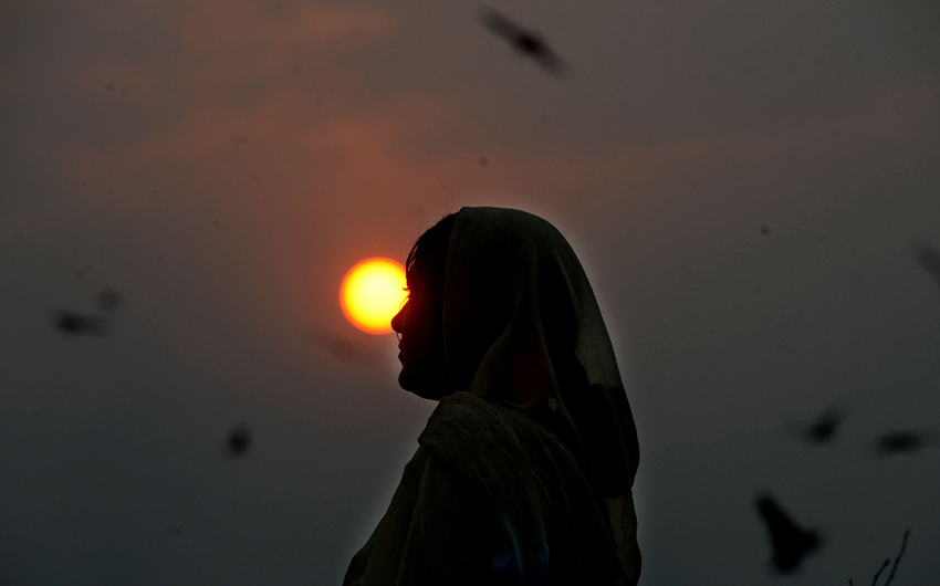 A gypsy woman walks during sunset in Pakistan on January 31, 2013. (AFP/File)
