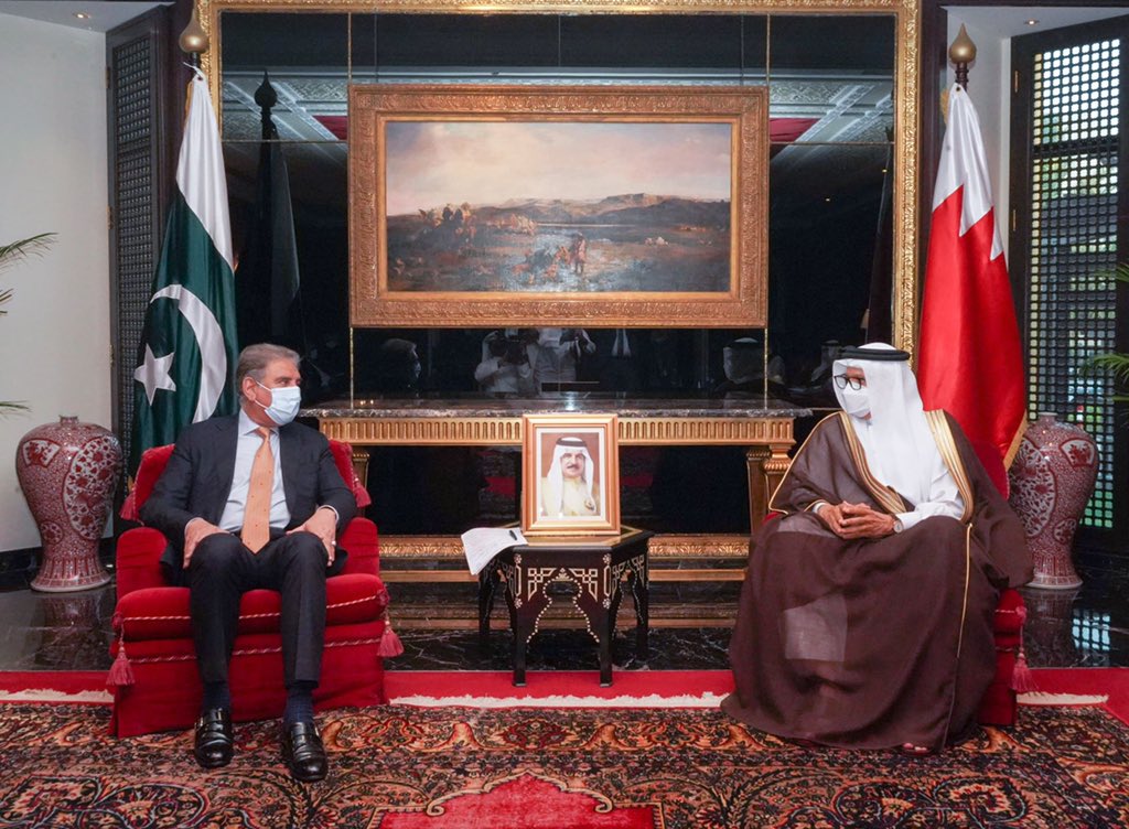 Pakistani Foreign Minister Shah Mahmood Qureshi (left) speaks to Bahraini Foreign Minister Dr. Abdullatif bin Rashid Al-Zayani (right) in Bahraini capital Manama on July 28, 2021. (Photo courtesy: Bahrain's ministry of foreign affairs)