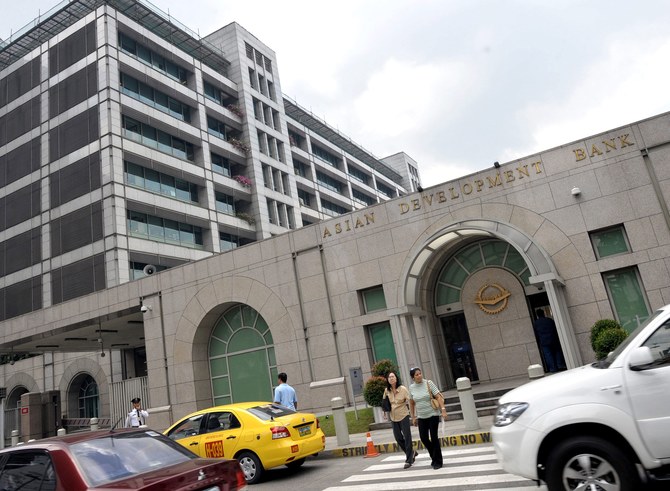 Cars drive past the Manila headquarters of the Asian Development Bank on February 17, 2009. (AFP/ File Photo)
