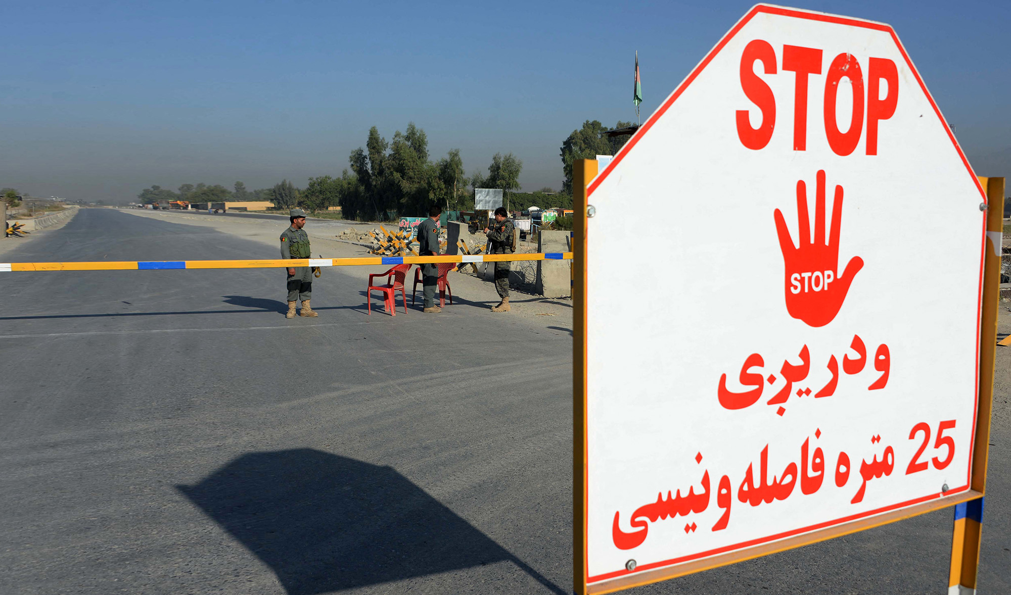 Afghan security personnel stand at a checkpoint outside Jalalabad Airport on October 2, 2015. (AFP/File)
