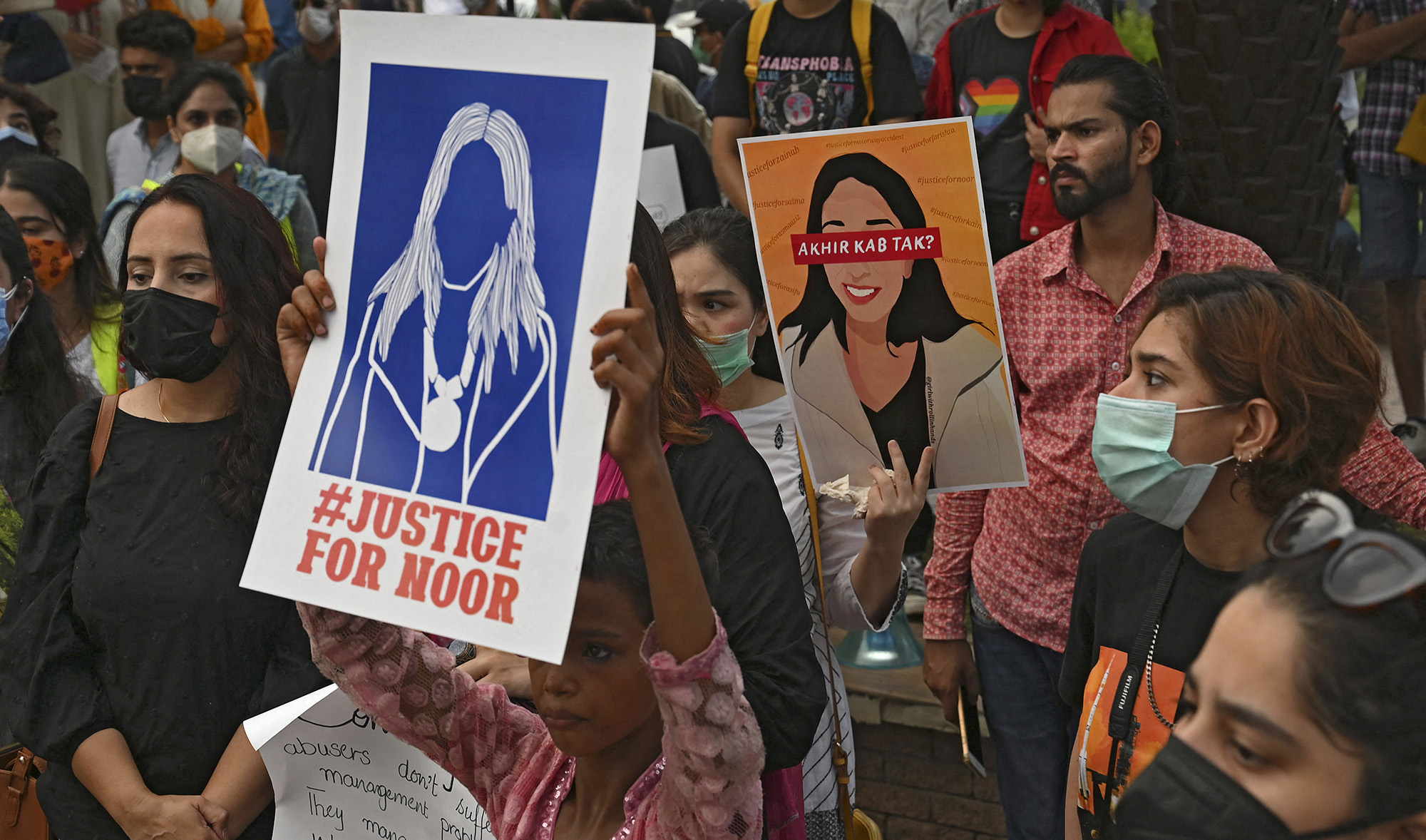 Women rights activists hold placards during a demonstration in Lahore on July 24, 2021, against the brutal killing of Noor Mukadam. (AFP)