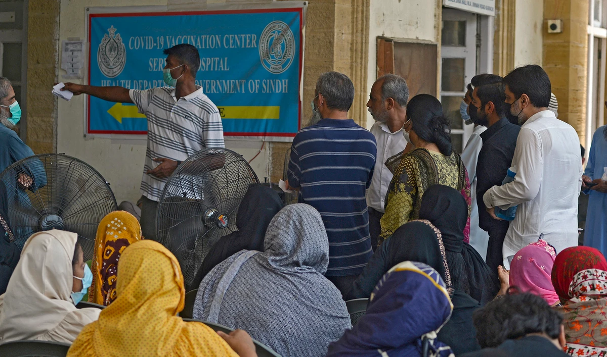 People queue up to register themselves to get inoculated with the jab of Covid-19 coronavirus vaccine at a vaccination camp held in karachi on May 22, 2021. (AFP/File)