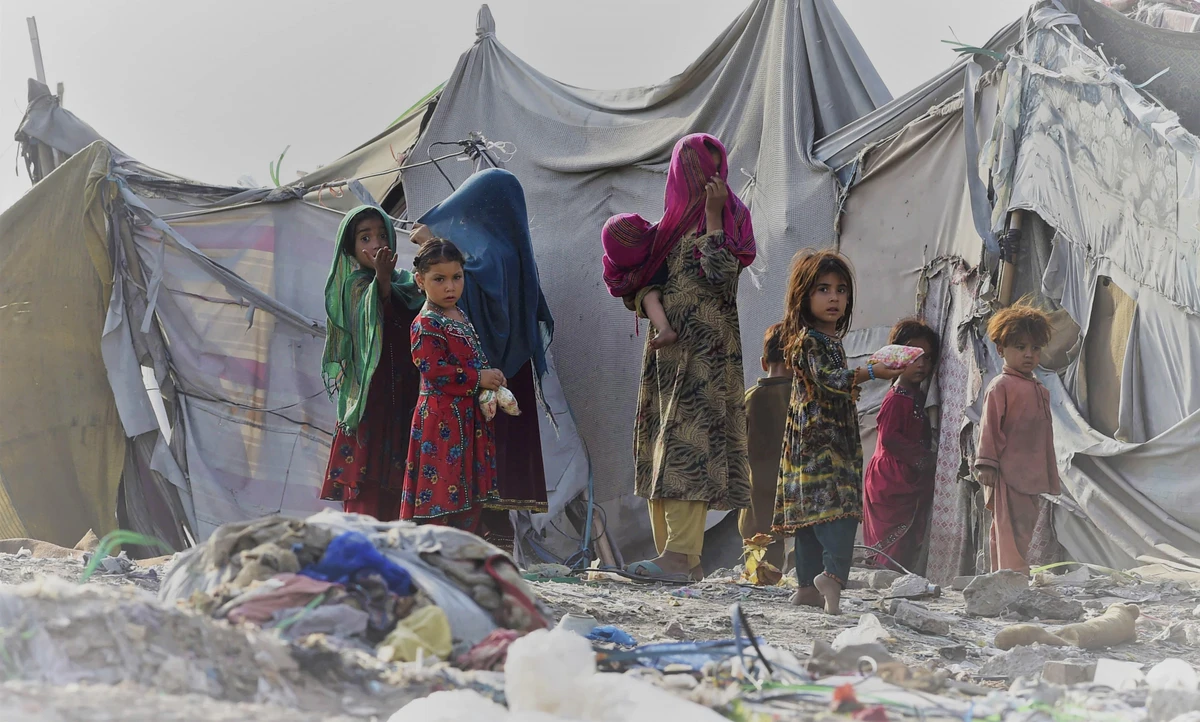 Children of Afghan refugees play outside tents in Afghan Basti area on the outskirts of Lahore on June 19, 2021. (AFP)
