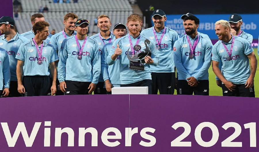England captain Ben Stokes holding the trophy with teammates after the third one day international (ODI) cricket match between England and Pakistan at Edgbaston cricket ground in Birmingham on July 13, 2021. (AFP)