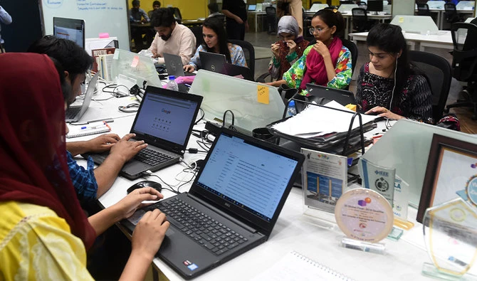 People work at their stations at a start-up incubator, in Lahore, Pakistan on on May 24, 2019. (AFP/File)