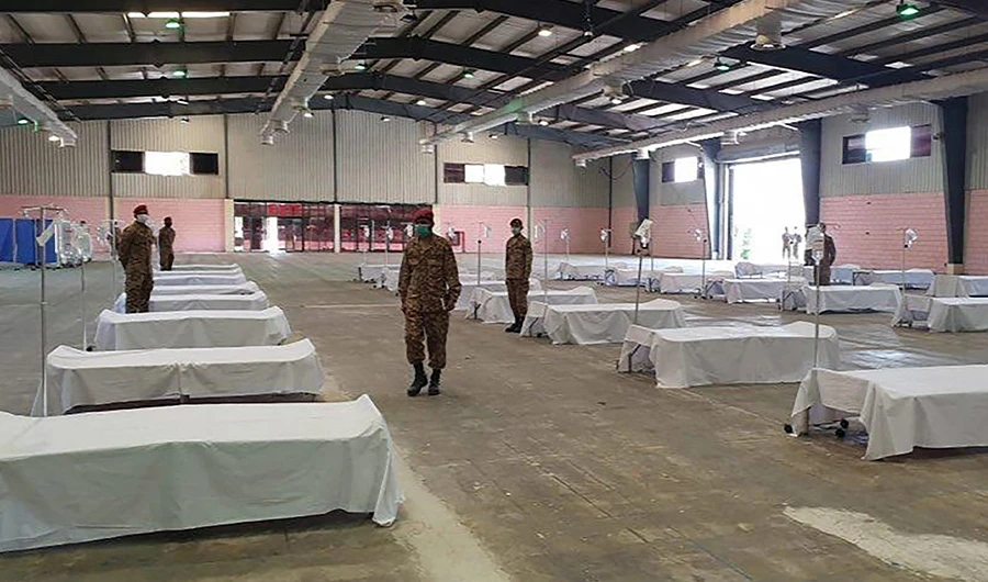 In this handout photograph taken and released by the Sindh Health Ministry on March 20, 2020, soldiers wearing facemasks are seen at the mass isolation center prepared in the Expo Center in Karachi. (AFP)