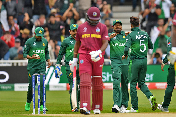 Pakistan's Mohammad Amir (R) celebrates with teammates after dismissing West Indies' Darren Bravo (C) during the 2019 Cricket World Cup at Trent Bridge in Nottingham, central England, on May 31, 2019. (AFP/File)
