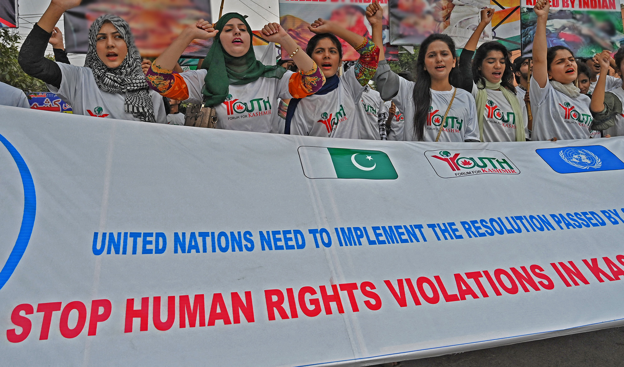 Activists of the 'Youth Forum for Kashmir' group carry placards as they shout slogans during a rally in protest against the Indian decision to strip the disputed Kashmir region of its special autonomy, in Lahore on September 24, 2019. (AFP/File)